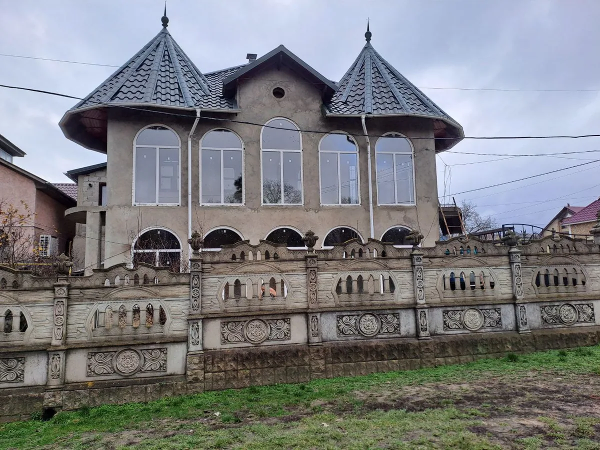 Ferestre termopan arcuite albe pe clădire cu acoperiș în stil turn